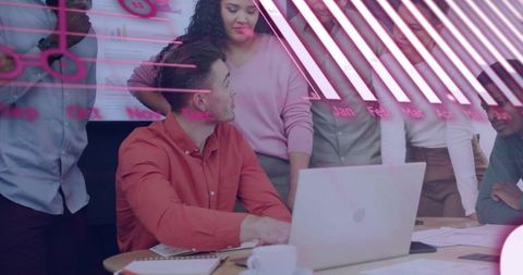 Team Collaborating Around Laptop with Pink Analytics Overlay and Strategic Planning