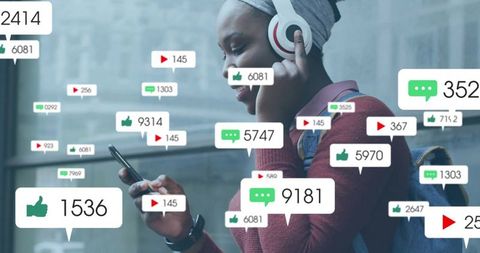 Young woman engaged with social media icons in urban train station