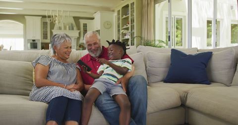 Grandparents and Grandson Enjoying Time Together on Couch
