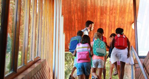 Diverse Group of Children Climbing Stairs with Backpacks in School Building - Download Free Stock Images Pikwizard.com