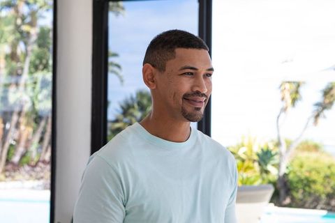 Casually dressed man relaxing at home by pool