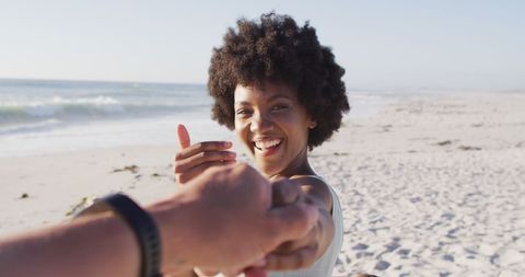 Joyful Woman Embracing Hand on Sandy Beach - Download Free Stock Images Pikwizard.com