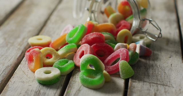 Assorted Gummy Candies Spilling from Jar on Wooden Table - Download Free Stock Images Pikwizard.com