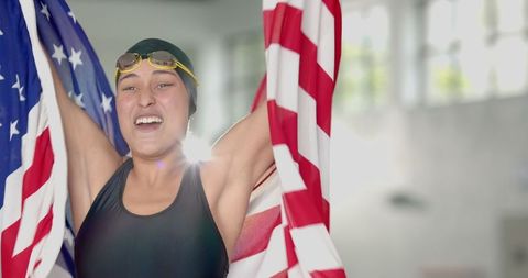 Female Swimmer Celebrates Victory Holding National Flag