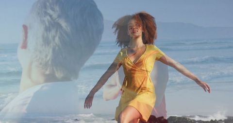 Woman in Yellow Dress Enjoying Ocean Breeze at Coast