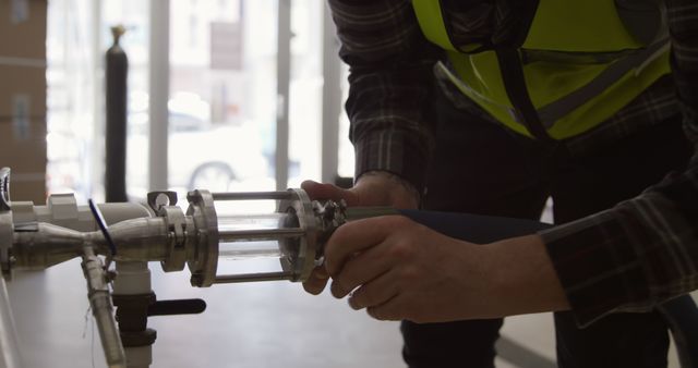 Technician Inspecting Stainless Steel Industrial Piping System - Download Free Stock Images Pikwizard.com