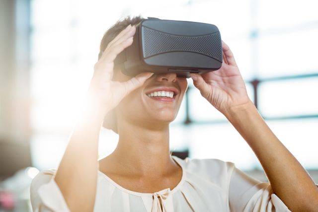 Young woman using the virtual reality headset at office