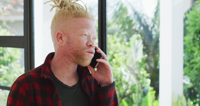 Albino African American Man Talking on Phone in Modern Home - Download Free Stock Images Pikwizard.com