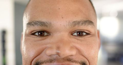 Close-Up Portrait of Smiling Man Showcasing Resilience and Strength