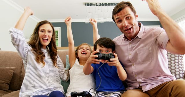 Excited Family Celebrating Video Game Victory at Home - Download Free Stock Images Pikwizard.com