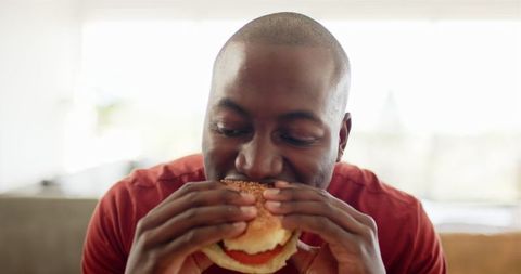 Man Enjoying Delicious Burger at Home - Download Free Stock Images Pikwizard.com