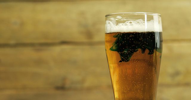 Glass of Beer with Shamrock Art against Wooden Background - Download Free Stock Images Pikwizard.com