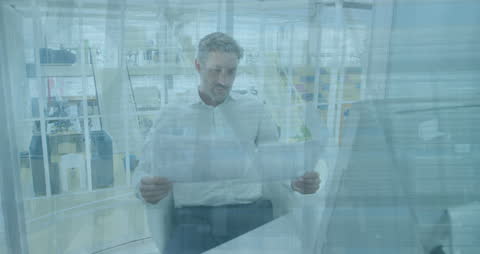 Businessman Analyzing Reports in Modern office with Financial Overlays