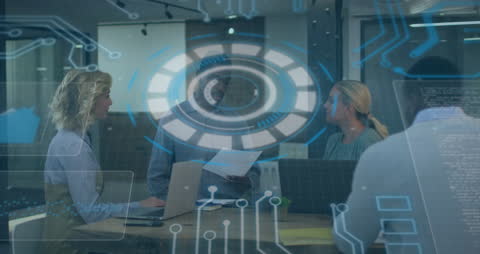 Innovative Team Collaborating Amidst Digital Interfaces