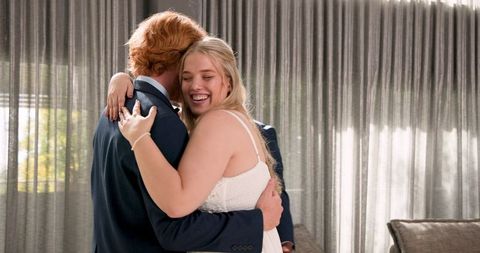 Newlywed couple celebrating with friends at wedding reception