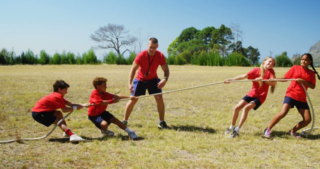 Children Playing Tug of War with Coach Outdoors - Download Free Stock Images Pikwizard.com