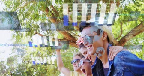Smiling friends taking selfie under sunlit canopy with augmented reality hud overlays