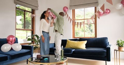 Couple decorating living room for festive celebration