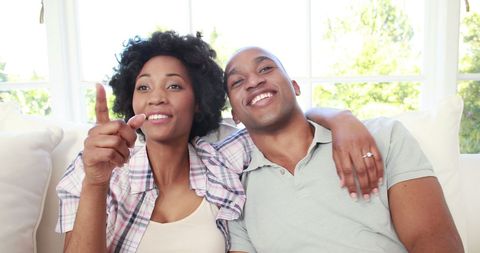 Happy African American Couple Relaxing on Couch with Smiles - Download Free Stock Images Pikwizard.com