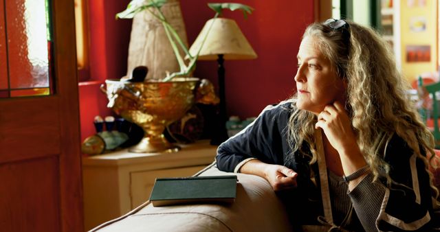 Mature Woman Reflecting by Window in Cozy Living Room - Download Free Stock Images Pikwizard.com