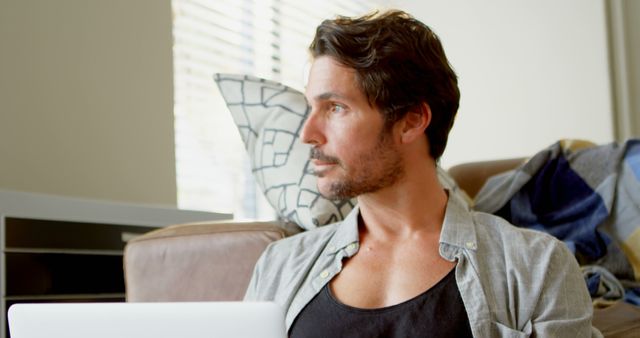 Focused man working on laptop at home - Download Free Stock Images Pikwizard.com