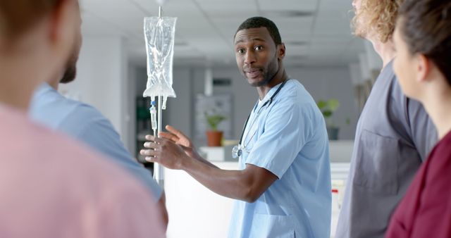 Healthcare professional explaining IV procedure to medical team - Download Free Stock Images Pikwizard.com