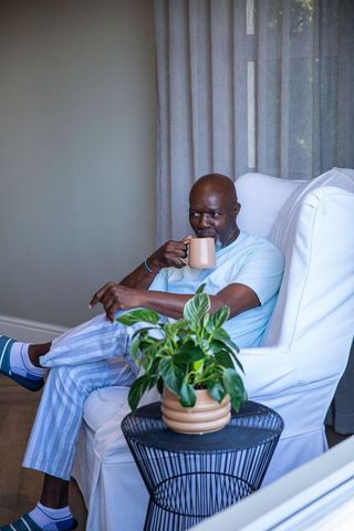 Senior Man Enjoying Leisure Time at Home with a Warm Drink