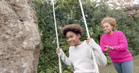 Mother and Son on Tree Swing in Garden Enjoying Leisure Time - Download Free Stock Images Pikwizard.com