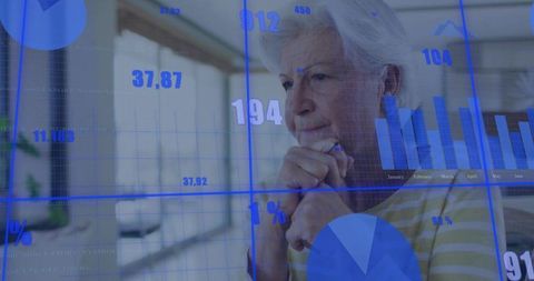 Senior woman analyzing financial charts with blue holographic overlays in modern workspace