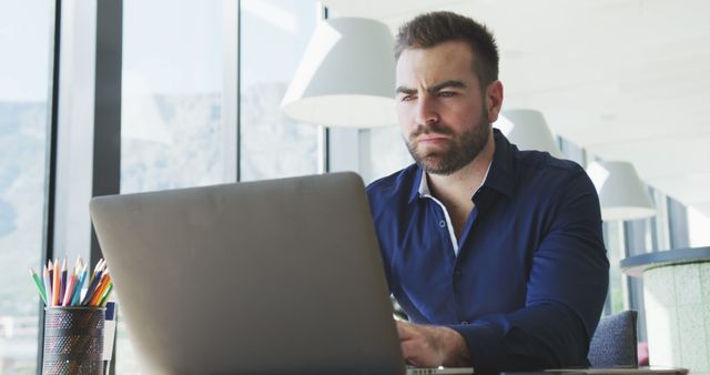 Caucasian Businessman Using Laptop in Modern Office with Copy Space - Download Free Stock Images Pikwizard.com