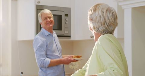 Senior Couple Enjoying Quality Time in a Sunlit Kitchen