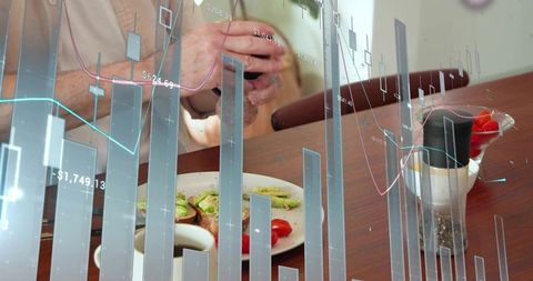 Man holding smartphone viewing AR financial charts during breakfast with avocado toast