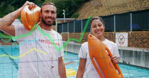 Smiling lifeguards holding rescue buoys at outdoor pool for water safety and teamwork
