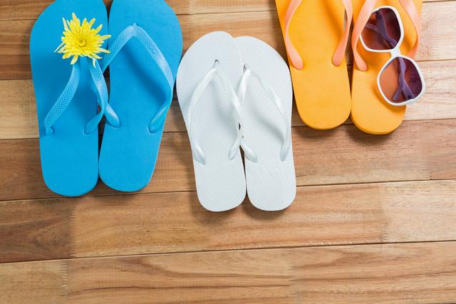Colorful Beach Flip Flops and Sunglasses on Wooden Floor - Download Free Stock Photos Pikwizard.com