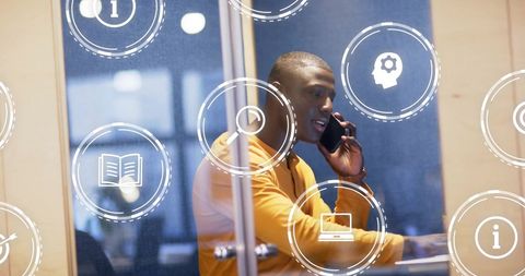 Businessman in Office Using Smartphone with Digital Icons