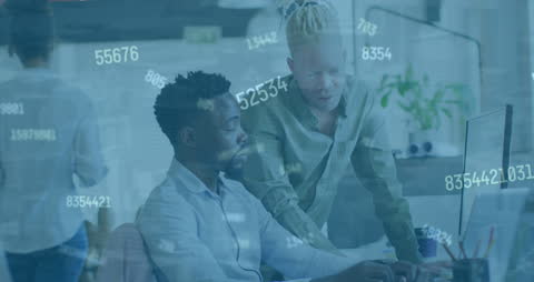 Diverse Colleagues Collaborating on Data Analysis in Modern Office