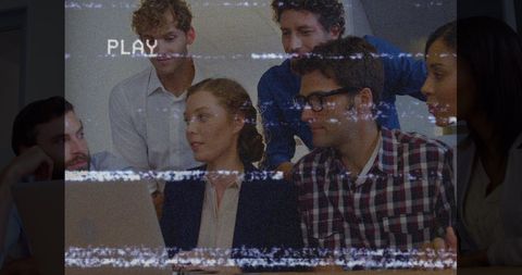 Diverse coworkers collaborating in high-tech office with digital glitch overlay
