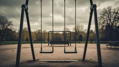 Empty Swing Set in Quiet Park during Overcast Day