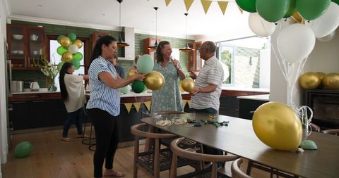 Happy multigenerational friends decorating home for celebration