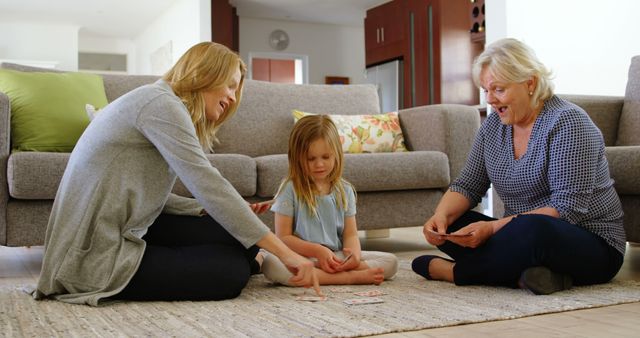 Three Generations Enjoying Card Game in Cozy Living Room - Download Free Stock Images Pikwizard.com