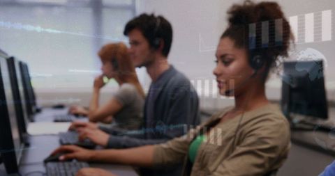 Customer Service Team Typing at Computers Wearing Headsets Modern Call Center Training