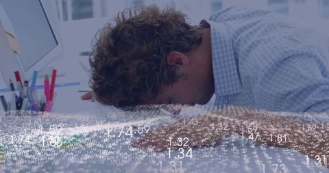 Leaning analyst resting head on desk amid floating data overlay, workplace burnout concept