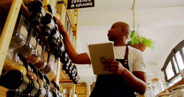 Shopkeeper Managing Inventory in Bulk Food Store - Download Free Stock Images Pikwizard.com