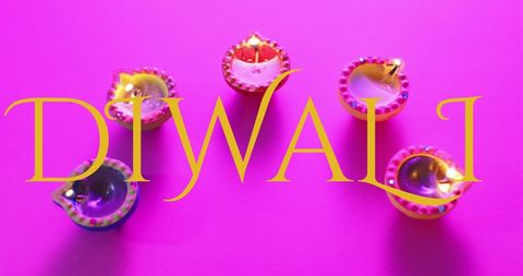 Diwali celebration letters over illuminated diyas on purple