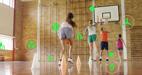 Youth athletes practicing basketball drill in gymnasium with green sustainability icons