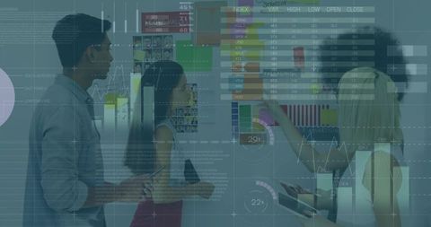 Business team reviewing interactive data wall, pointing at charts, tablets and analytics