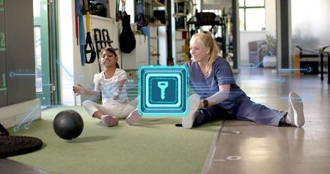 Pediatric therapist guiding child through interactive rehabilitation exercises with ar overlay