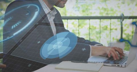 Businessman working on laptop on balcony with augmented reality data interface