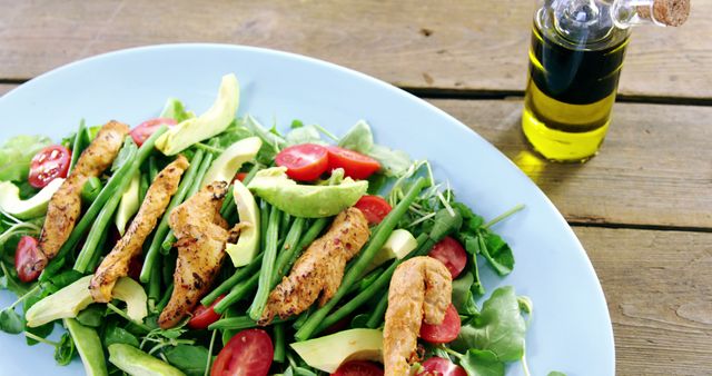 Healthy Grilled Chicken Salad with Avocado and Tomatoes on Blue Plate - Download Free Stock Images Pikwizard.com