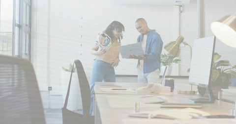 Collaborating with vr headset and laptop in modern office workspace showcasing innovation